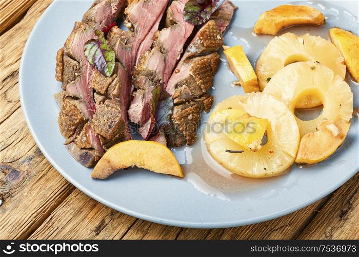 Roast duck fillet with spices.Baked duck breast with pineapple sauce. Roasted duck with pineapple