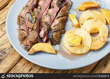 Roast duck fillet with spices.Baked duck breast with pineapple sauce. Roasted duck with pineapple