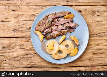 Roast duck fillet with spices.Baked duck breast with pineapple sauce.Rustic style. Roasted duck breast