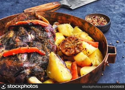 Roast mutton in the pan. Mutton cooked in a pan with potatoes and vegetables