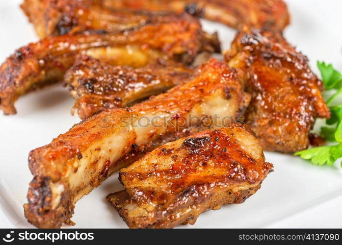 roast rib pork with parsley on a white plate