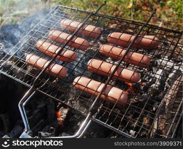 roast sausages on fire