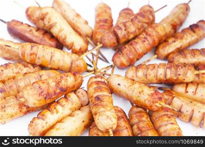 Roast sausages on thin sticks.