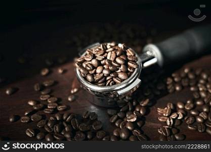 roasted beans in a portafilter with blur background. . roasted beans in a portafilter