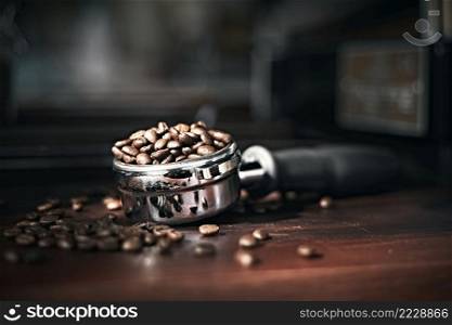 roasted beans in a portafilter with blur background. . roasted beans in a portafilter