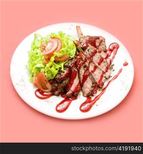 Roasted Beef meat at cranberries sauce with vegetables