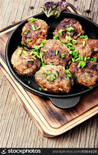 Roasted beef meatballs in cast-iron skillet.Delicious cutlet. Meatballs in cast iron skillet
