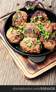 Roasted beef meatballs in cast-iron skillet.Delicious cutlet. Meatballs in cast iron skillet