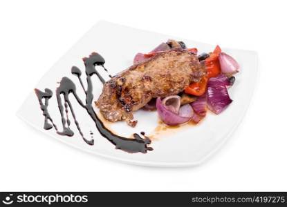 Roasted beef steak with vegetable closeup at plate