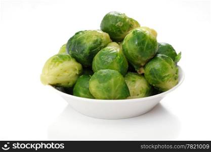 roasted brussels sprouts on a white plate, studio isolated