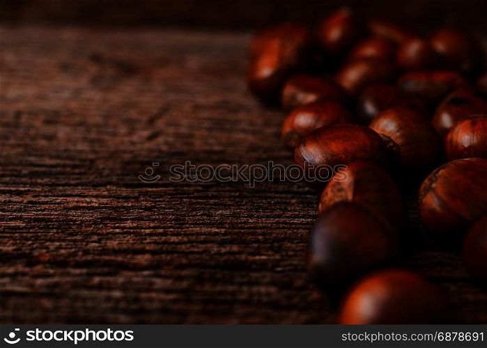 roasted chestnuts on wood background