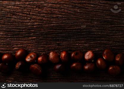 roasted chestnuts on wood background