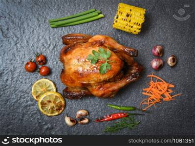 Roasted chicken / baked whole chicken grilled with on herbs and spices and dark background on top view
