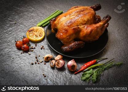 Roasted chicken / baked whole chicken grilled with on herbs and spices and dark background