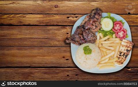 Roasted chicken dish with gallo pinto and pico de gallo on wooden table, Top view of roasted chicken dish with rice t french fries served on wooden background, Concept of typical Nicaraguan food