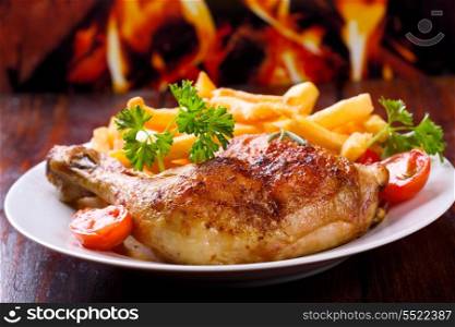 roasted chicken leg with fries potato and herbs