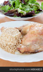 Roasted chicken leg with rice and salad