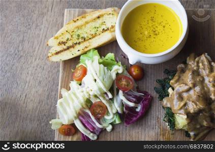 Roasted chicken served with salad and garlic bread