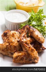 Roasted Chicken wings and tzatziki sauce on a plate. Chicken wings