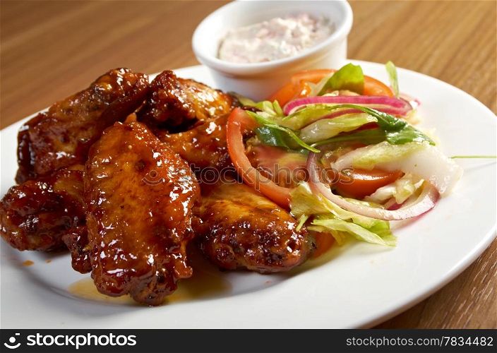 Roasted chicken wings on plate.Shallow depth-of-field.