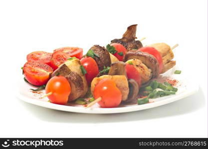 Roasted chicken with mushrooms and tomatoes. Isolated.