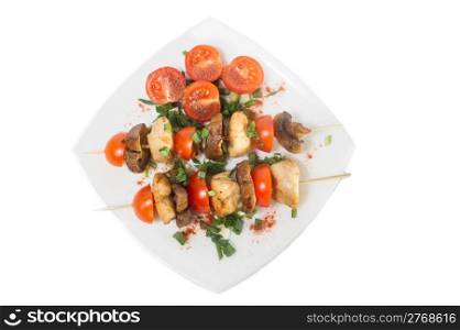 Roasted chicken with mushrooms and tomatoes. Isolated.
