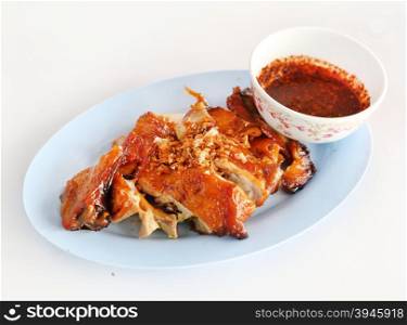 roasted chicken with sauce thai style on white table