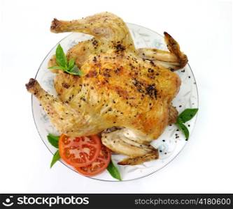Roasted chicken with spices , tomatoes and basil leaves