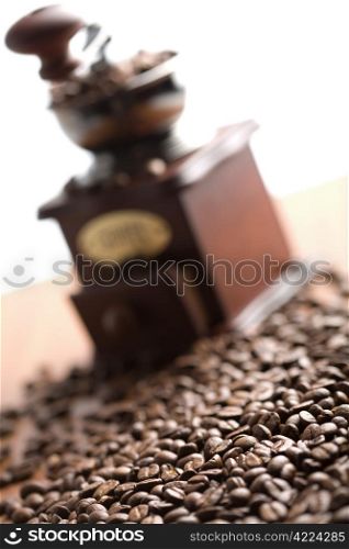 roasted coffee beans and coffee gringer isolated