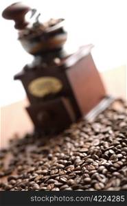 roasted coffee beans and coffee gringer isolated