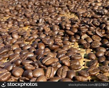 Roasted Coffee Beans background texture. Arabic roasting coffee - ingredient of hot beverage. Brown coffee beans for background and texture. 