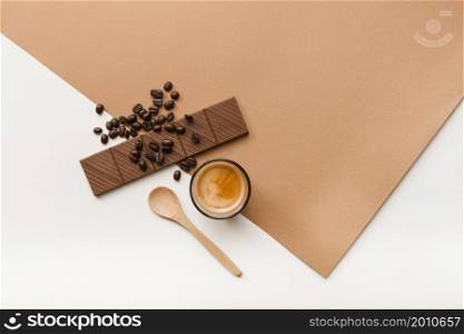 roasted coffee beans chocolate bar coffee glass with spoon background