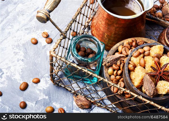 Roasted coffee beans. Coffee pot with coffee beans,sugar and spice