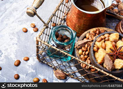 Roasted coffee beans. Coffee pot with coffee beans,sugar and spice