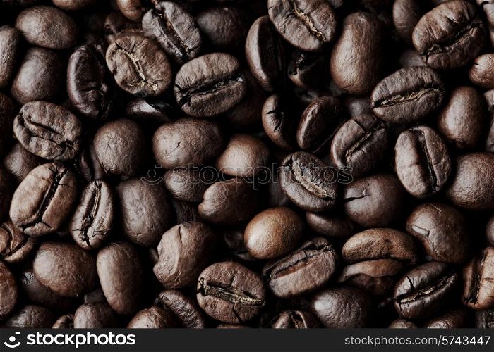 Roasted Coffee beans dark background macro close-up. Coffee beans background