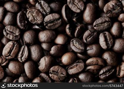 Roasted Coffee beans dark background macro close-up. Coffee beans background