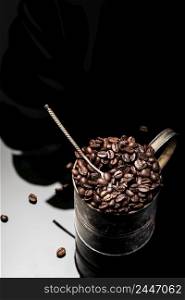 Roasted coffee beans in a metal vintage mug. Focus on fragrant grains, vertical frame