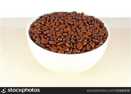 Roasted coffee beans in a white bowl