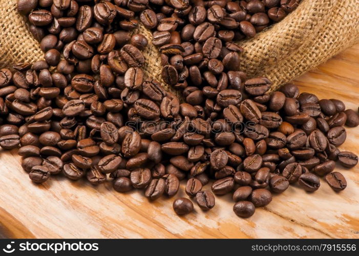 roasted coffee beans on a rough sackcloth closeup