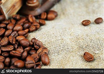 roasted coffee beans on sacking, background
