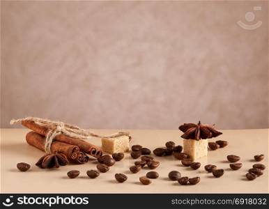 Roasted coffee beans. Roasted coffee beans and cinnamon sticks on wooden table