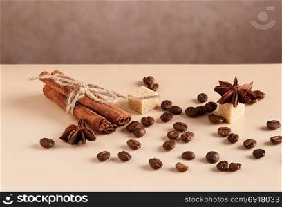 Roasted coffee beans. Roasted coffee beans and cinnamon sticks on wooden table