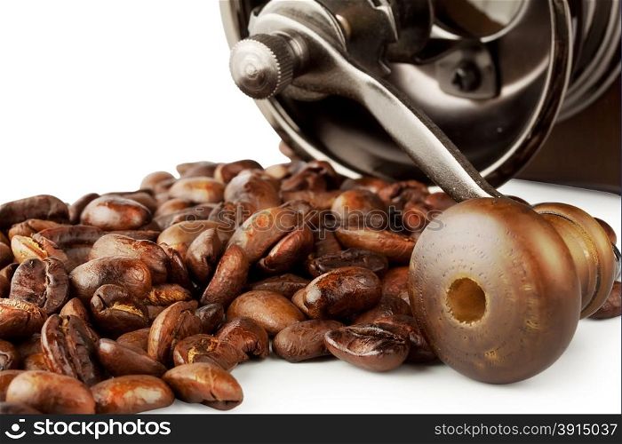 Roasted coffee beans with coffee grinder isolated on white background
