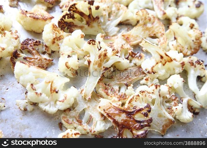 roasted, cut up cauliflower with coarse salt