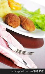roasted cutlets of pork with potato and lettuce