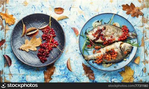 Roasted dorado fish with viburnum berries.Healthy food. Dorado baked with viburnum
