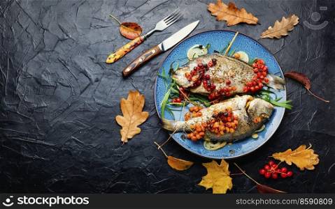 Roasted dorado fish with viburnum berries.Healthy food.Space for text. Dorado baked with viburnum,copy space