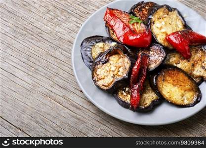 Roasted eggplants and grilled bell pepper on a plate. Tasty grilled eggplants slices, bbq