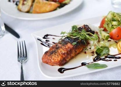 roasted fish, rice and vegetables on dish