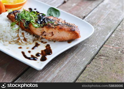 roasted fish, rice and vegetables on dish